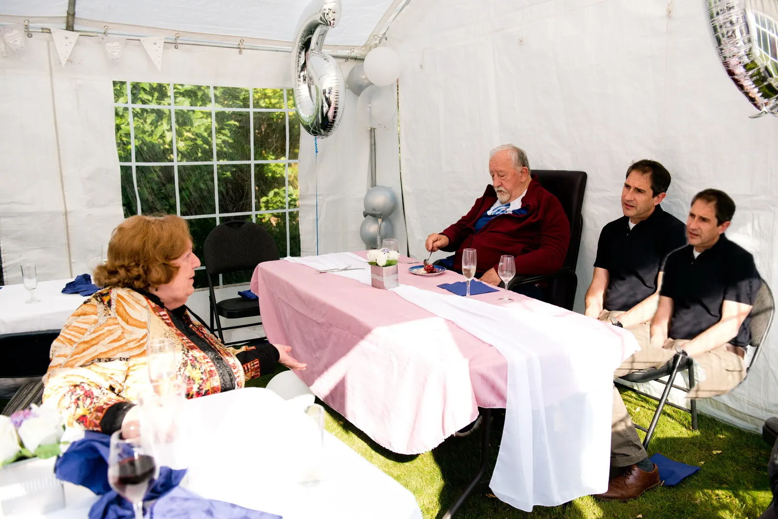 Evening garden party under an Estate marquee with lanterns