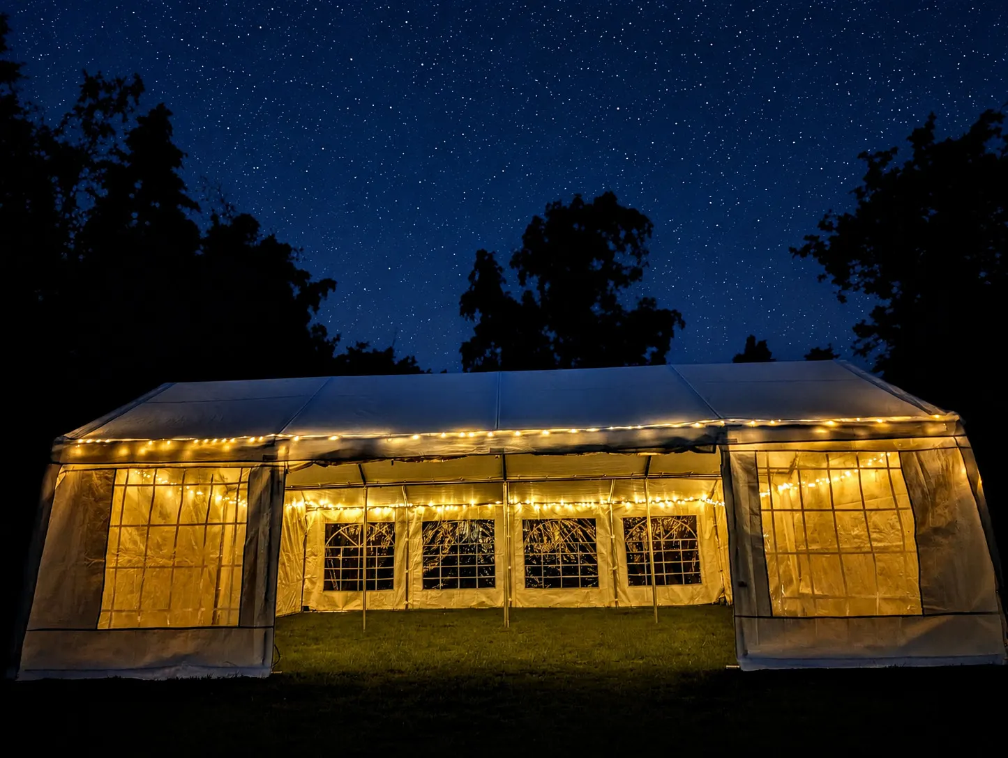 The Estate 8x4 marquee glowing under a starry sky