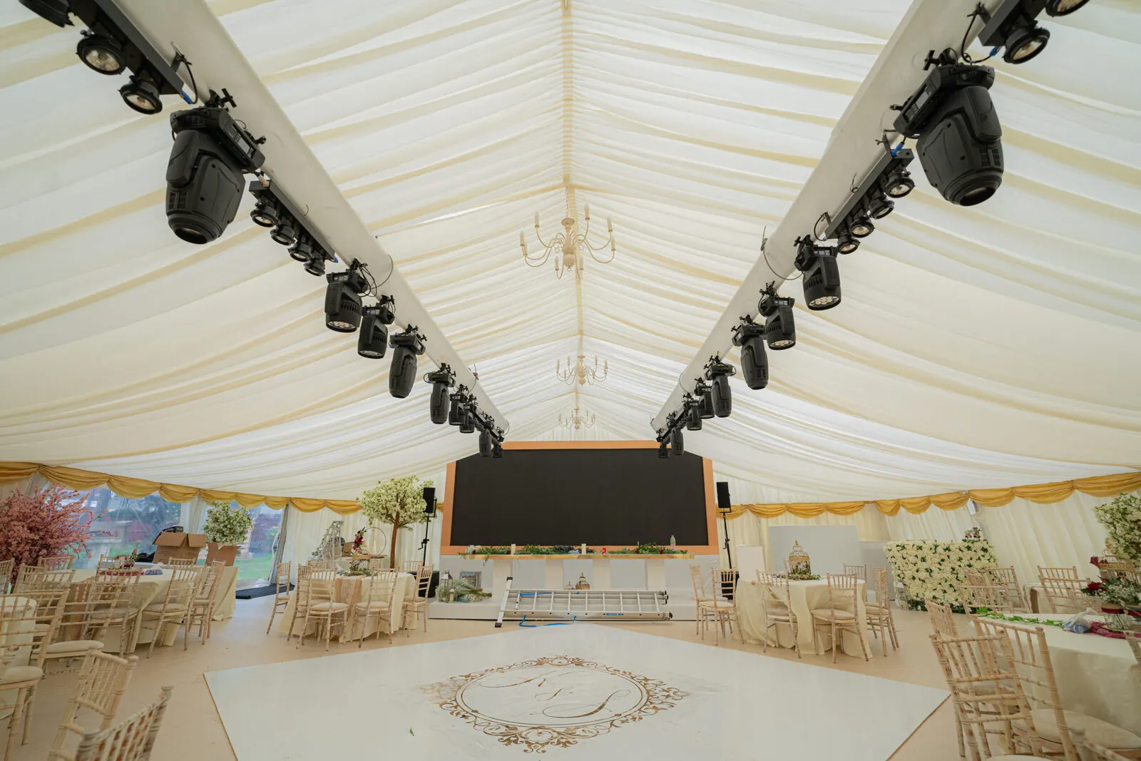 Lined wedding marquee with dance floor and lighting